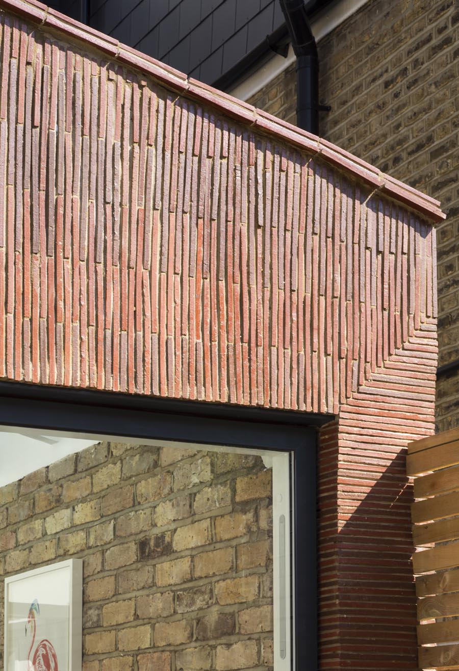 Stacked creasing tiles clad new extension in London