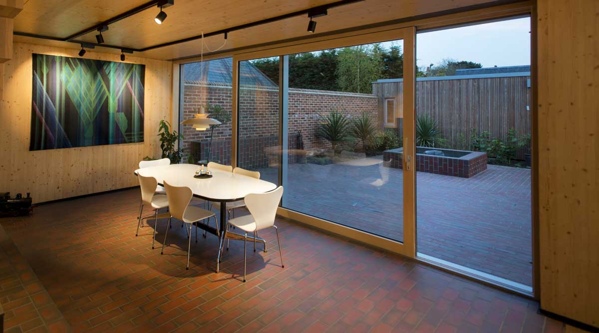 A blend of light and dark multi quarry tiles unite the indoor and outdoor spaces