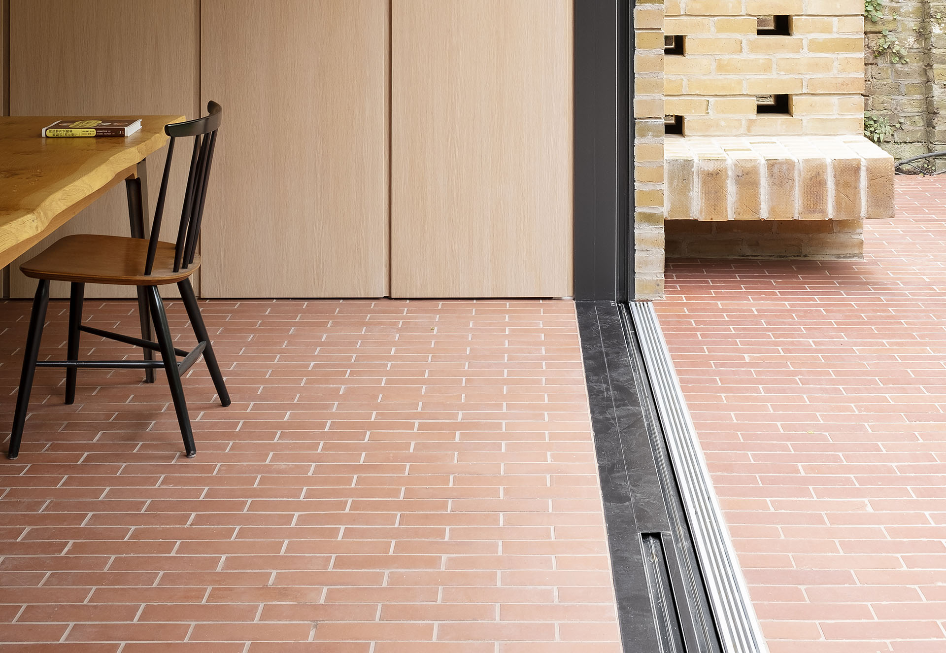 Ketley brick sized pavers blend the indoor outdoor space at this London home