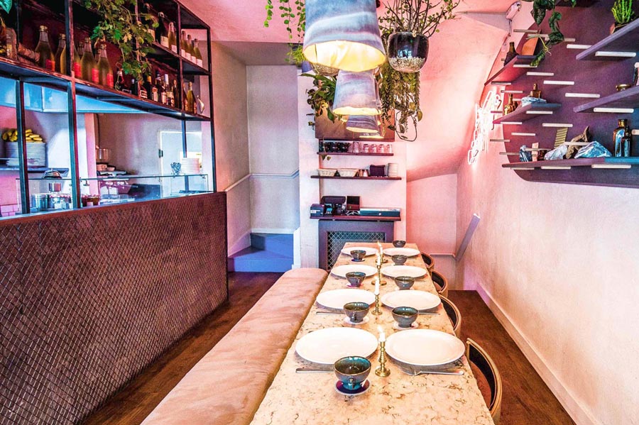 Mamies in Covent Garden use Ketley diamond chequer pavers on the wall to frame the open kitchen area