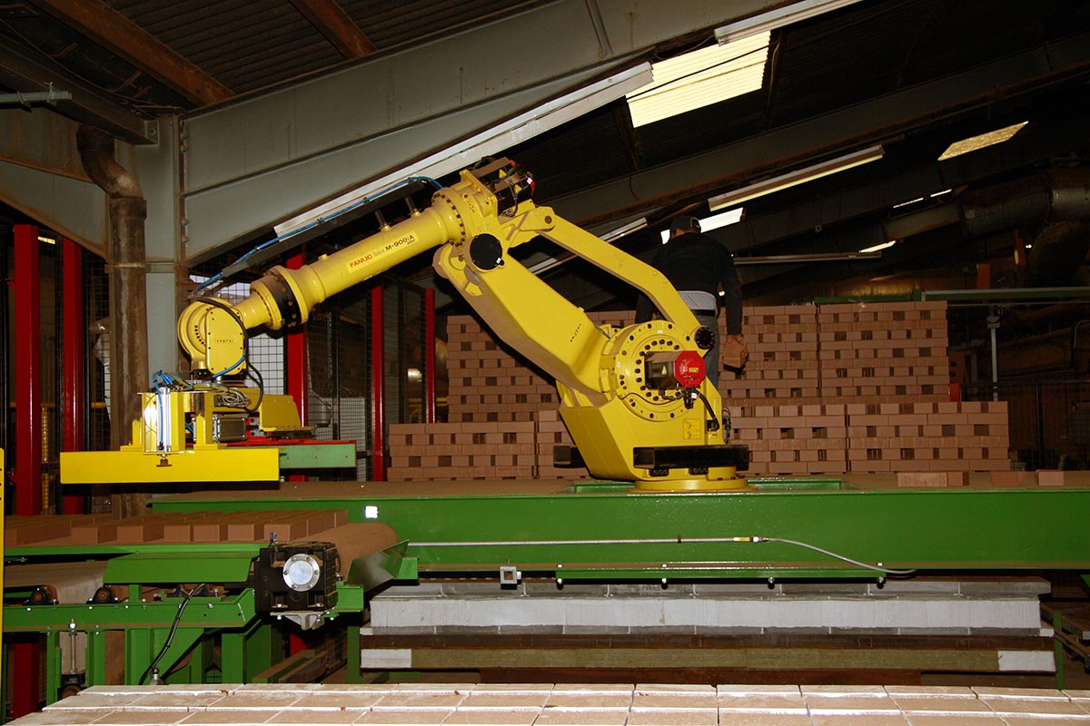 a robot sets bricks for the kiln cars