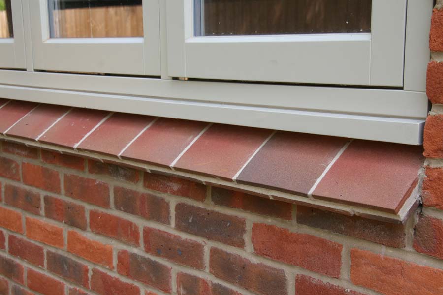 country brown sanded tiles used as creasing tiles for an external cill
