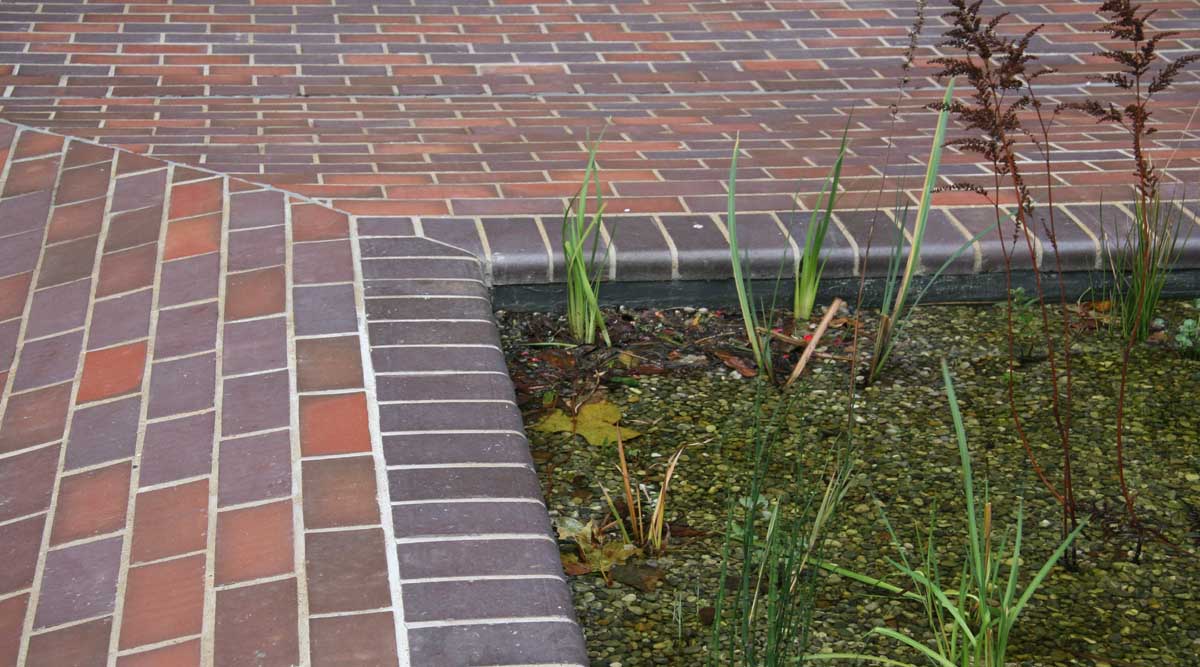 curved edge quarry tiles surround the water at the Barbican