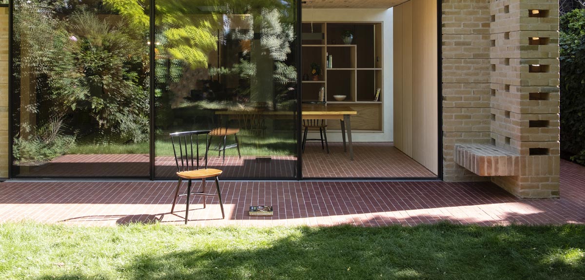 red brick sized quarry tiles unite the indoor and outdoor spaces in the London home
